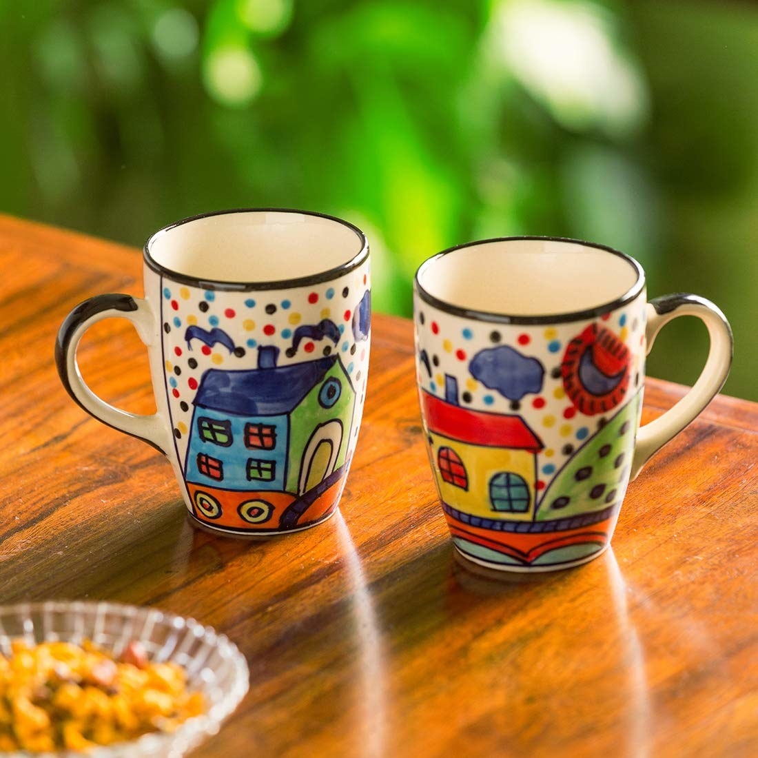 Two mugs with houses on them