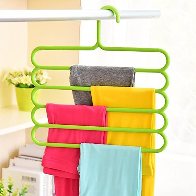 Green hanger with clothes hanging off every layer.