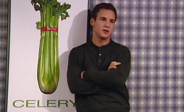 Cory Matthews standing next to a celery poster.