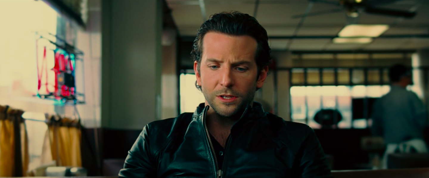 Bradley Cooper in a zipped up leather jacket with a button down underneath