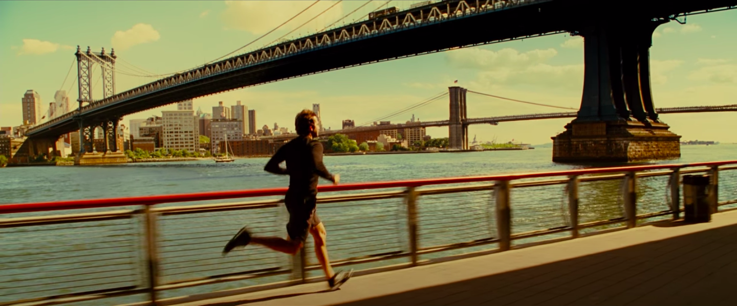 Bradley Cooper running in a long-sleeve workout shirt, shorts and running shoes