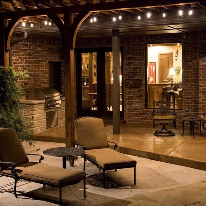 Bistro lights hung above an outdoor patio space