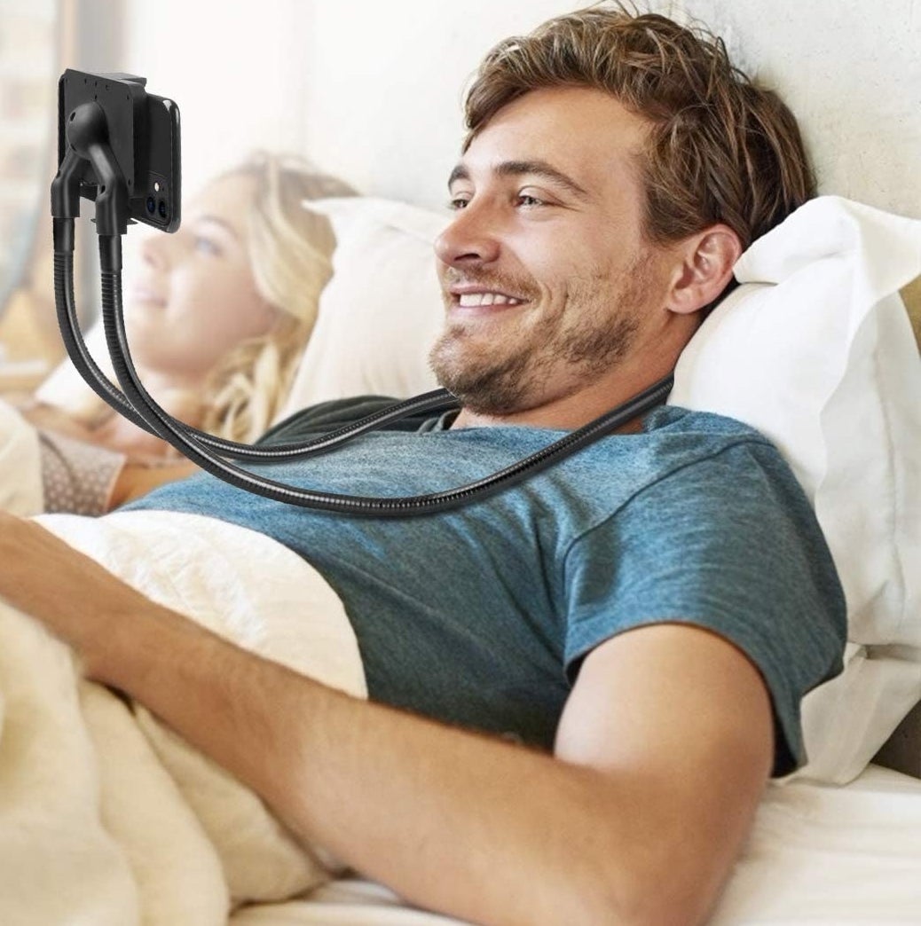 A person wearing the phone mount in bed