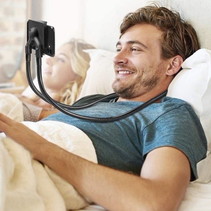 A person wearing the phone mount in bed