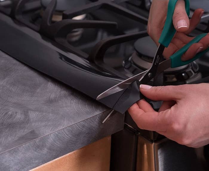 A person trimming the gap filler