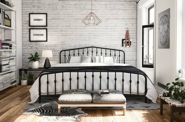 A cozy bedroom with a black metal bedframe