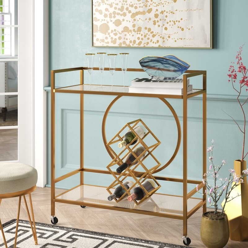 A gold bar cart in a living room 