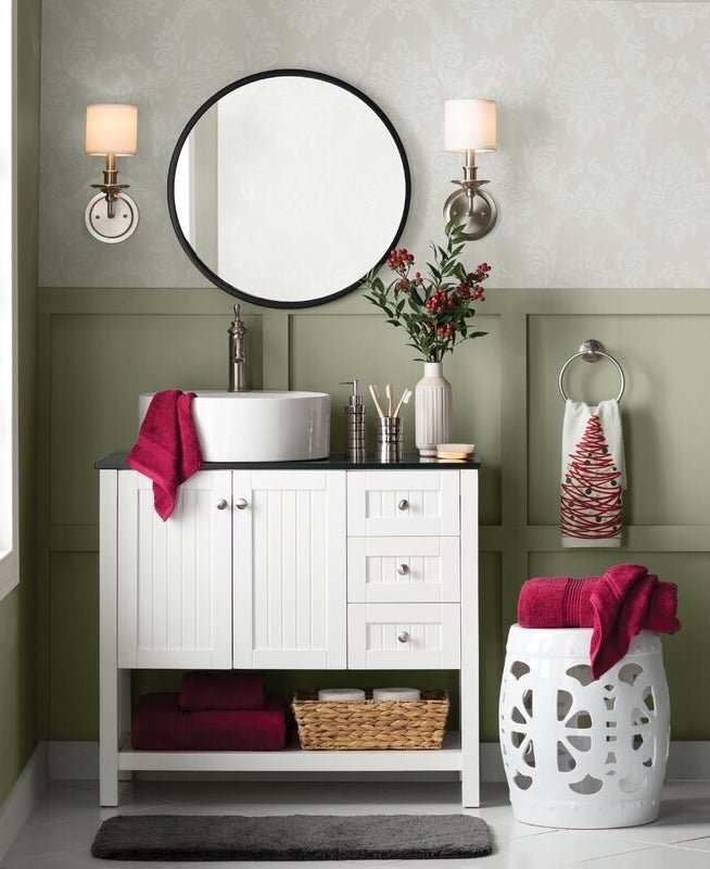 A bathroom vanity, sink and stool in white