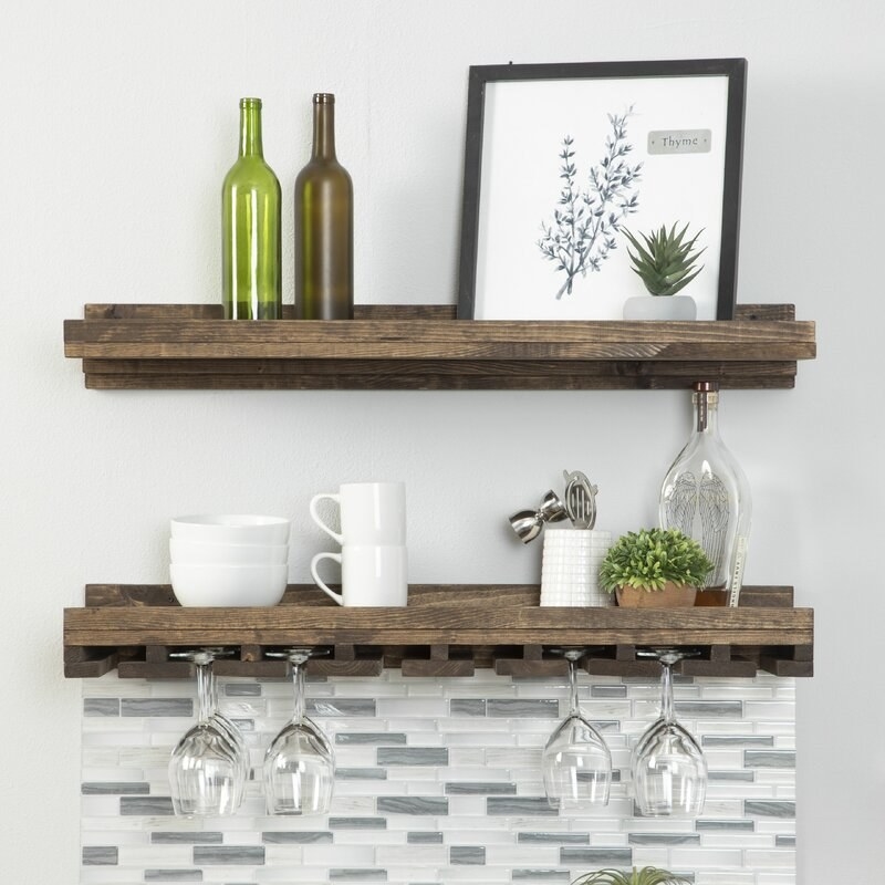 Brown wooden shelving with wine glasses and bottles