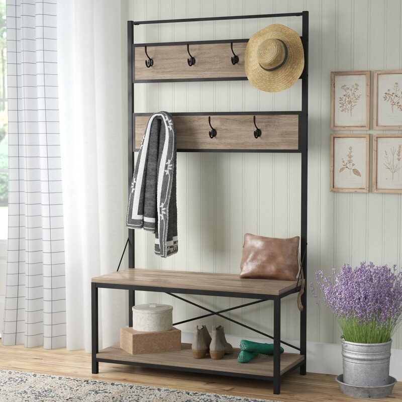 A bench with coat hooks in an entryway 