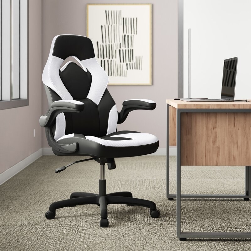 A black and white office chair next to a desk
