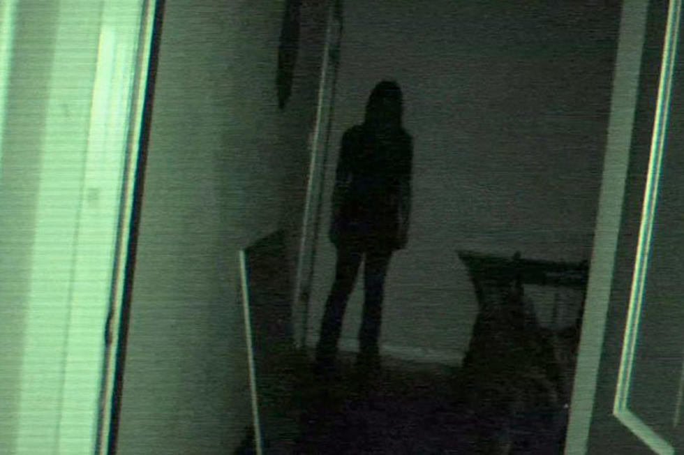 The dark shadow of a woman is at the end of the hallway