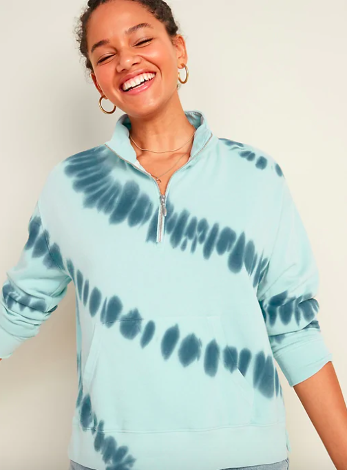 A smiling model wears the 3/4 zip sweatshirt
