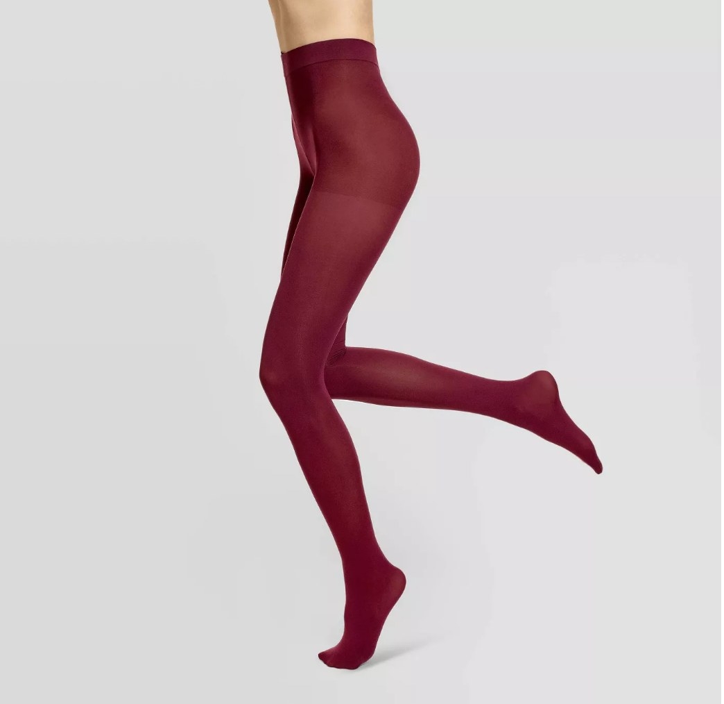 Model wearing maroon colored tights