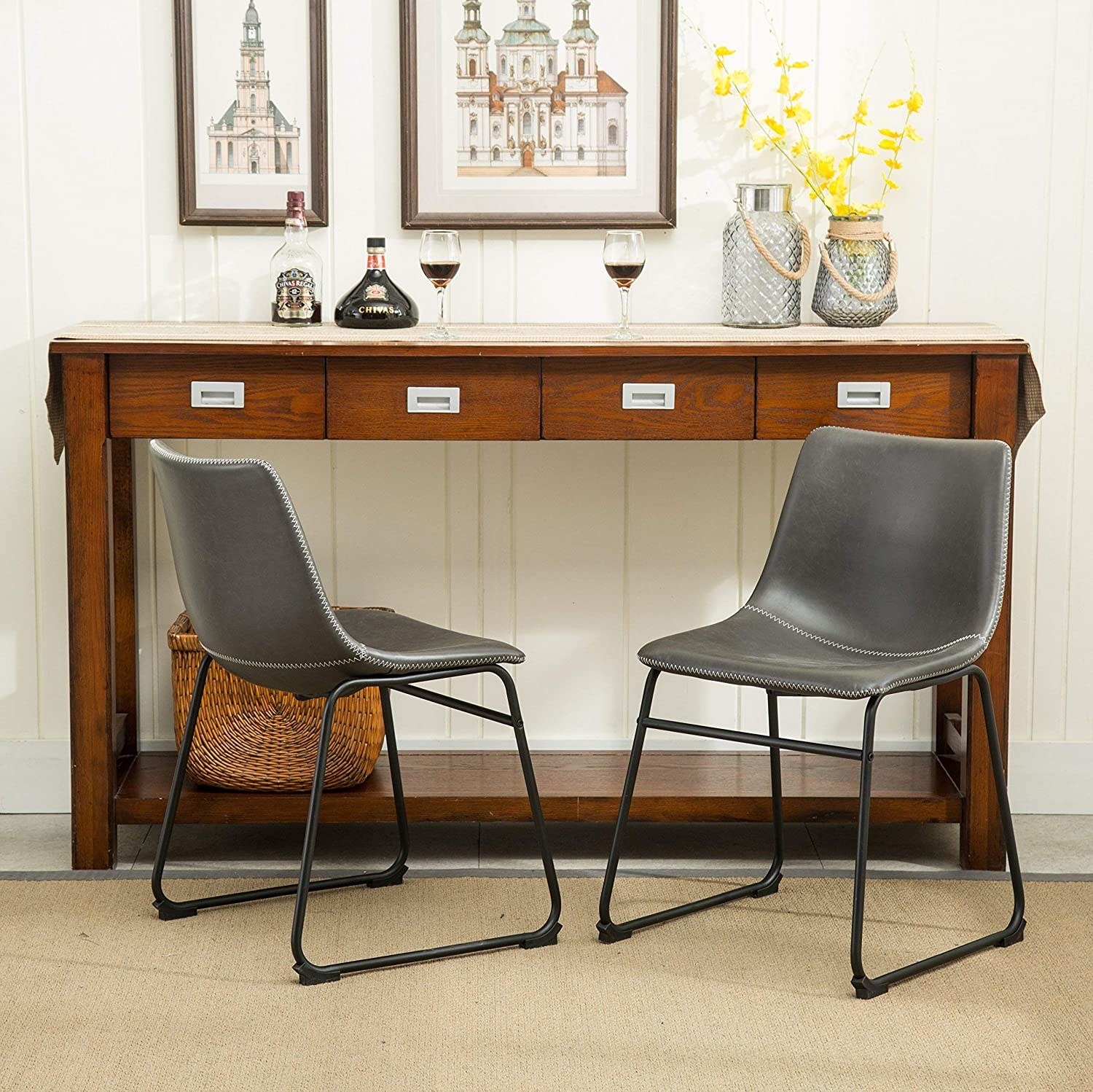 The gray leather armless chairs and black iron frame legs