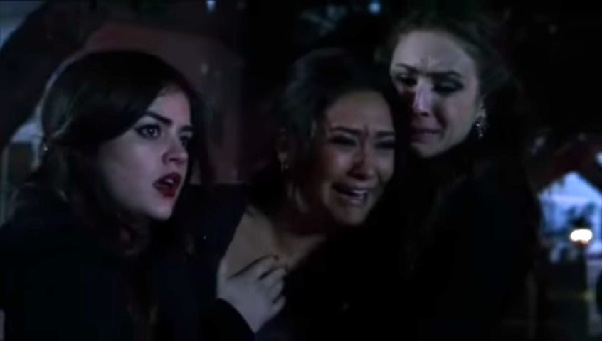 Emily screams at the crime scene as Aria and Spencer hold her back