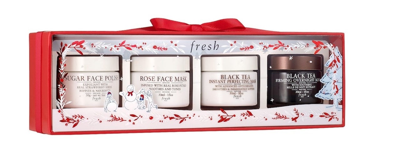 Four masks in holiday-themed packaging