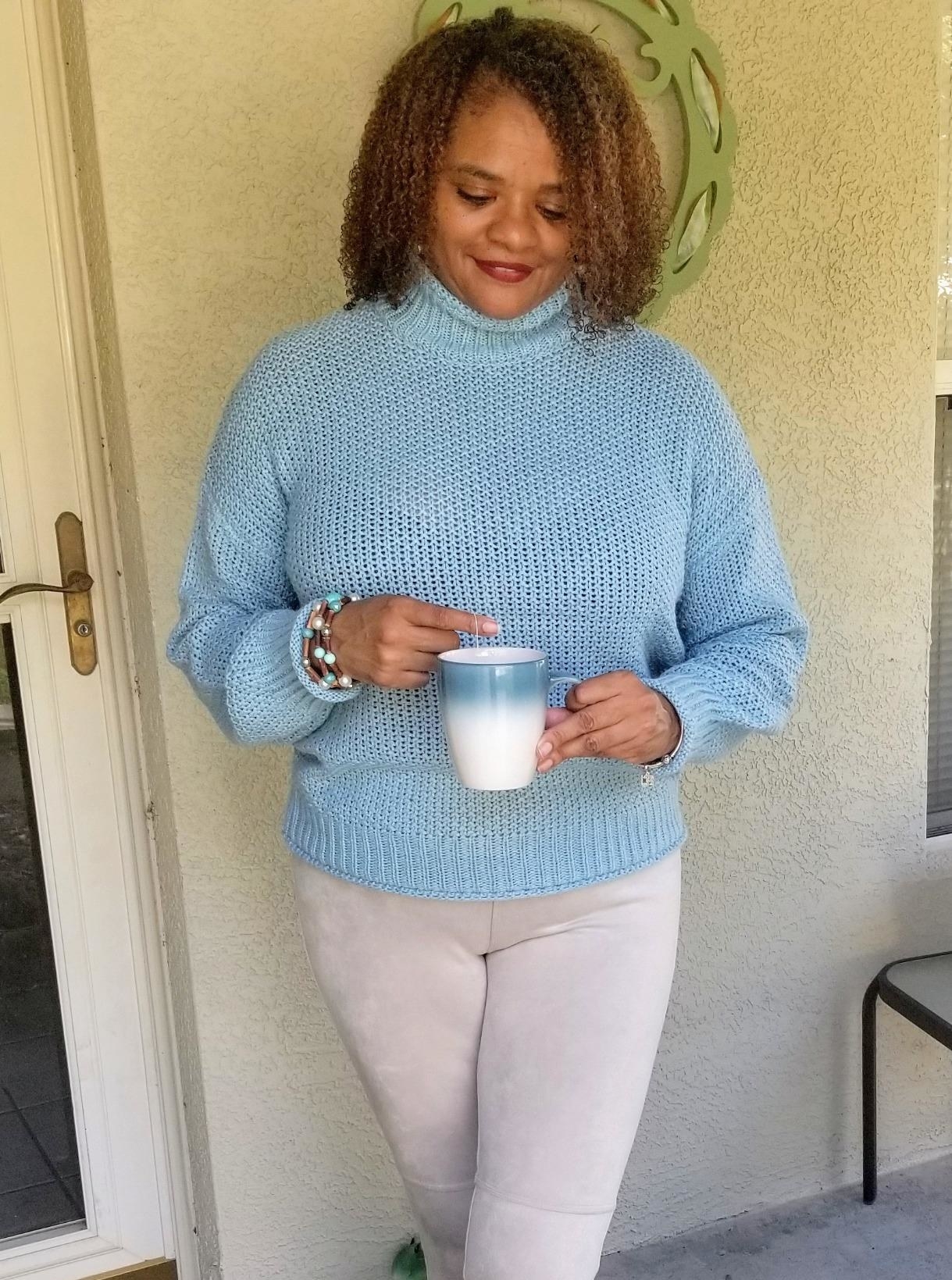 Reviewer wearing the turtleneck in light blue