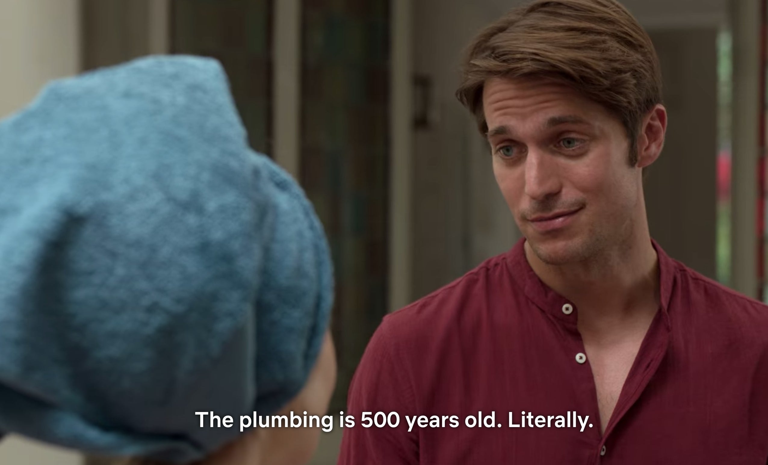 A scene from Emily in Paris that says &quot;The plumbing in 500 years old. Literally.&quot;