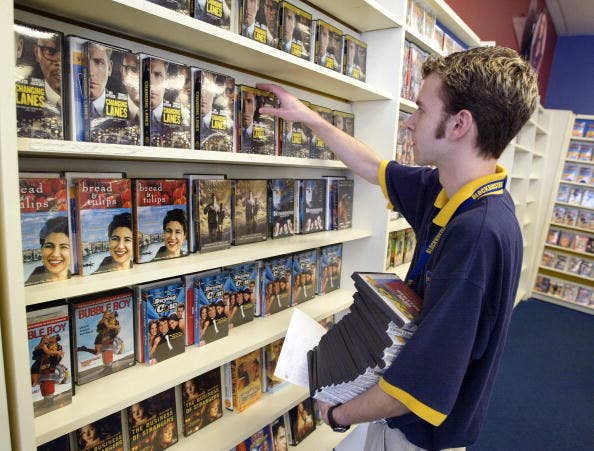 man browsing the blockbuster dvd section