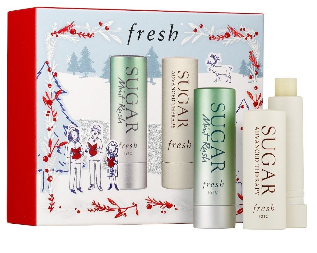 Two lip balm tins and festive packaging