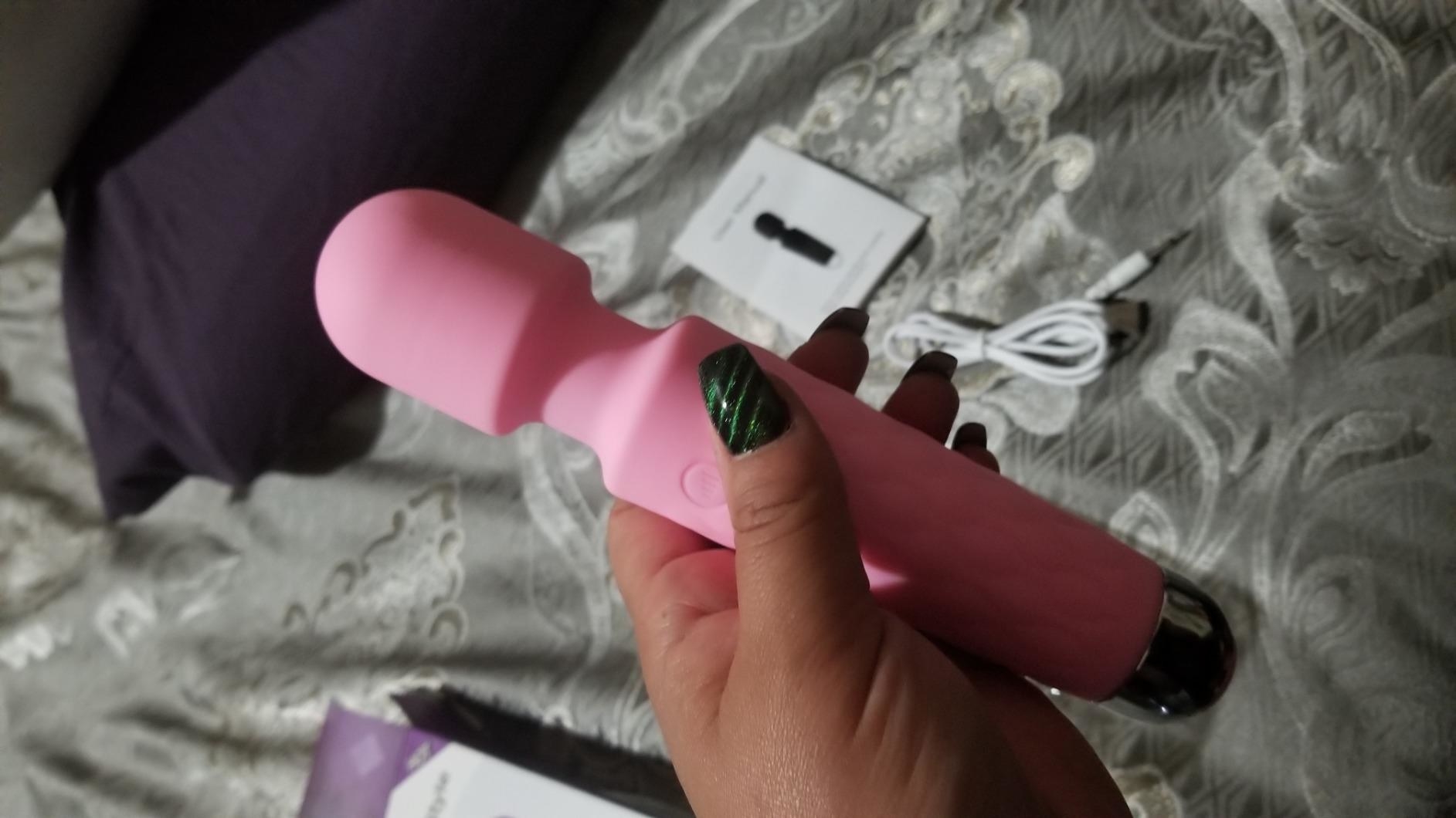 The pink Portable Personal Wand Massager in a customer&#x27;s hand