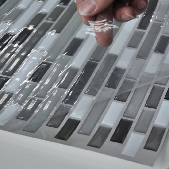 The tiles as they come packaged, on a sticker sheet with a layer of protective film