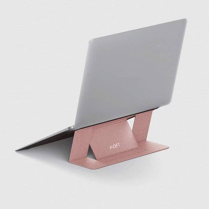 A laptop stand with the laptop on it