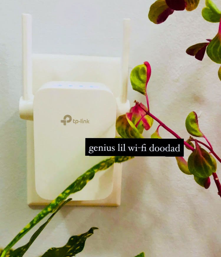 A wi-fi extender plugged into a wall