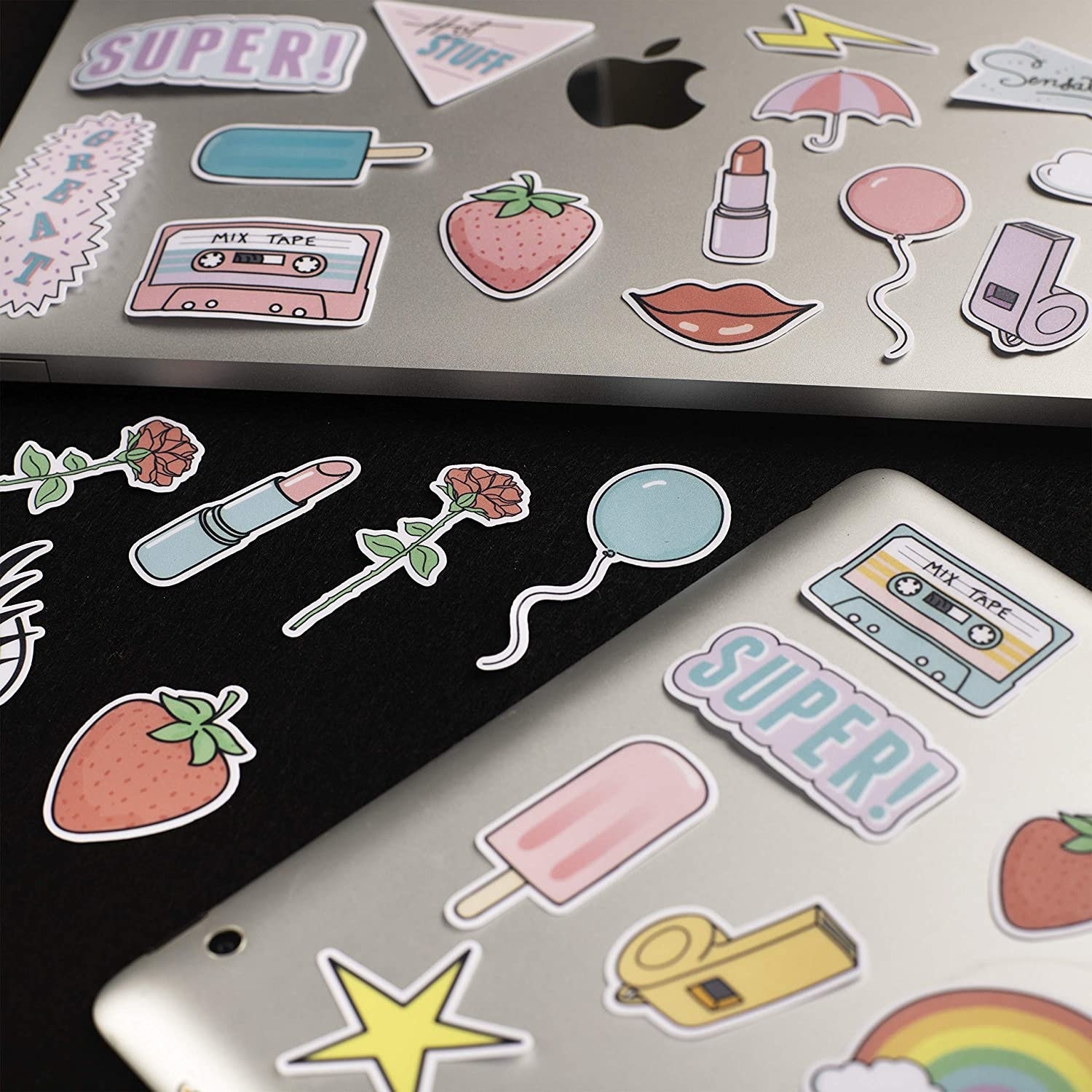 Several stickers on two laptop computers