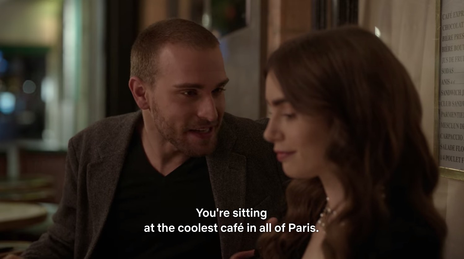 Emily being told &quot;You&#x27;re sitting at the coolest cafe in all of Paris.&quot;