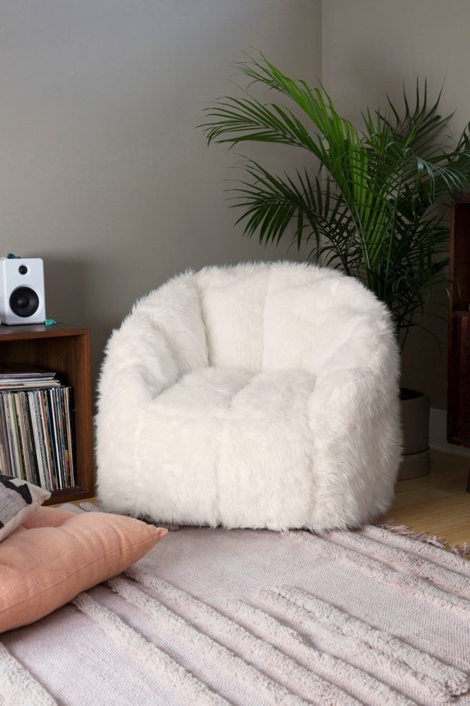 A stout white faux fur chair 