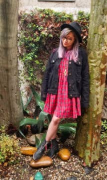 reviewer pic of the red dress with rain boot and a jacket 