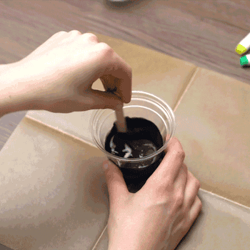 gif of someone drawing on black slime with bright chalk markers