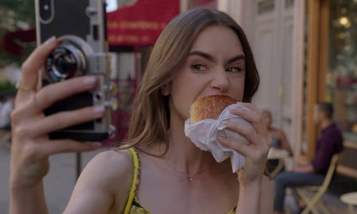 Emily eating a croissant on "Emily In Paris"