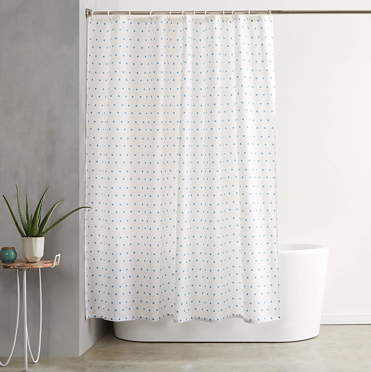 The shower curtain covering a free-standing tub