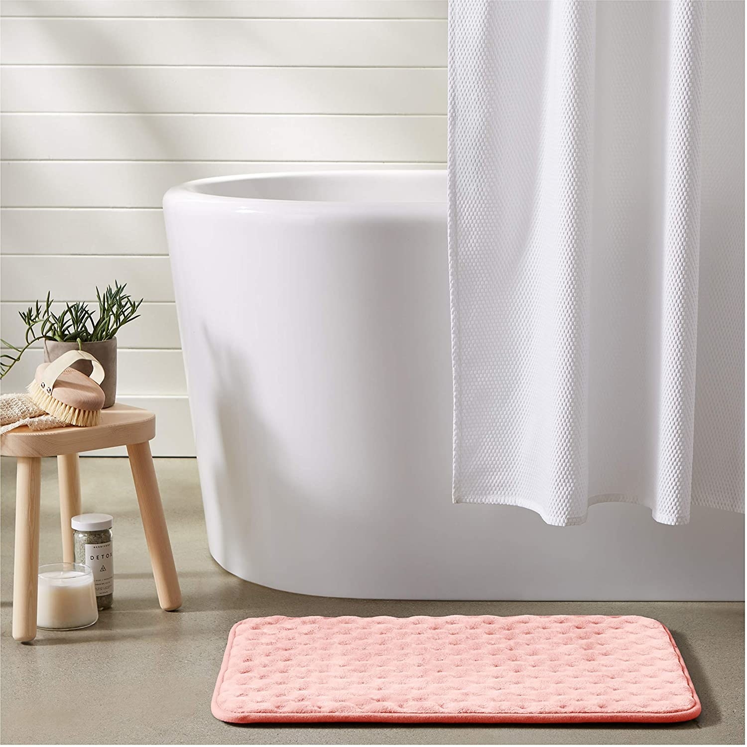 The textured bath mat next to a free-standing mat