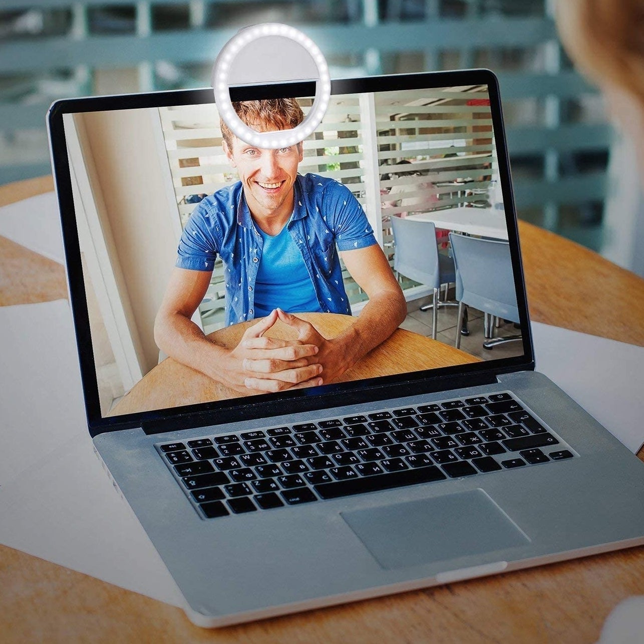 A laptop with the ring light clipped onto it