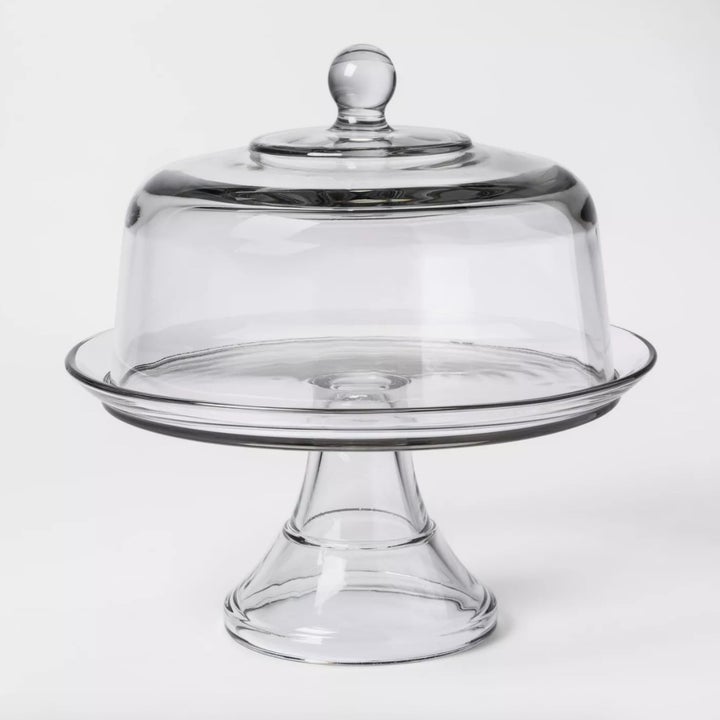 A glass cake stand with dome top