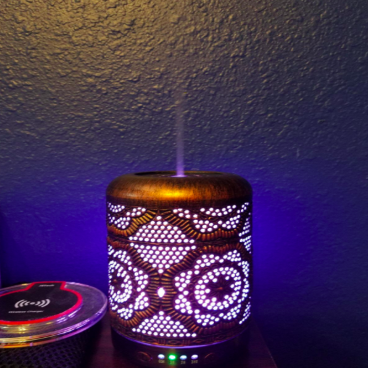 Reviewer uses same essential oil diffuser on a table next to a WiFi adapter 