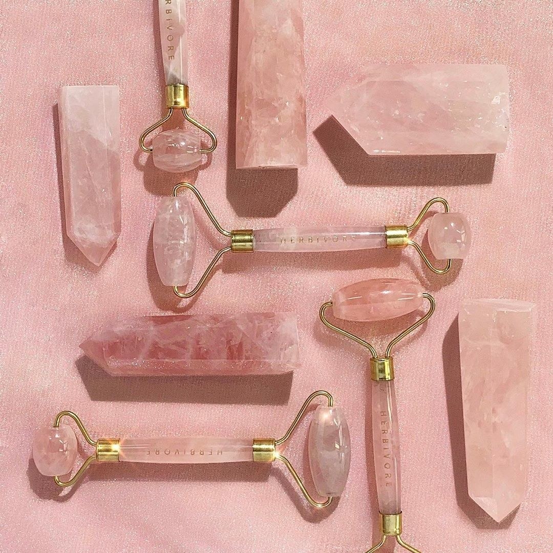 A set of rose quartz rollers with rose quartz crystal points