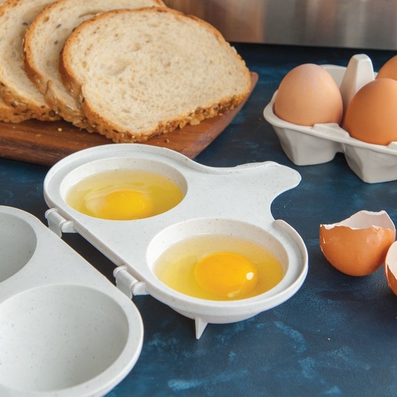 The egg poacher with two yolks in it 