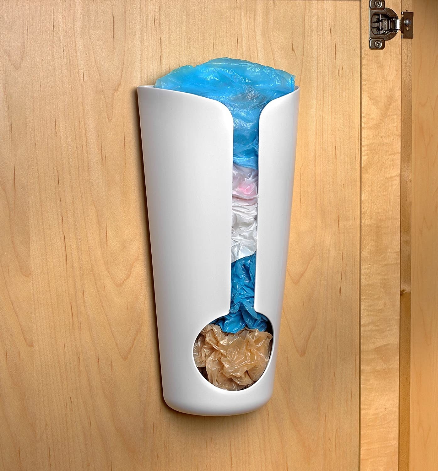 The plastic bag holder mounted on the inside of a kitchen cabinet