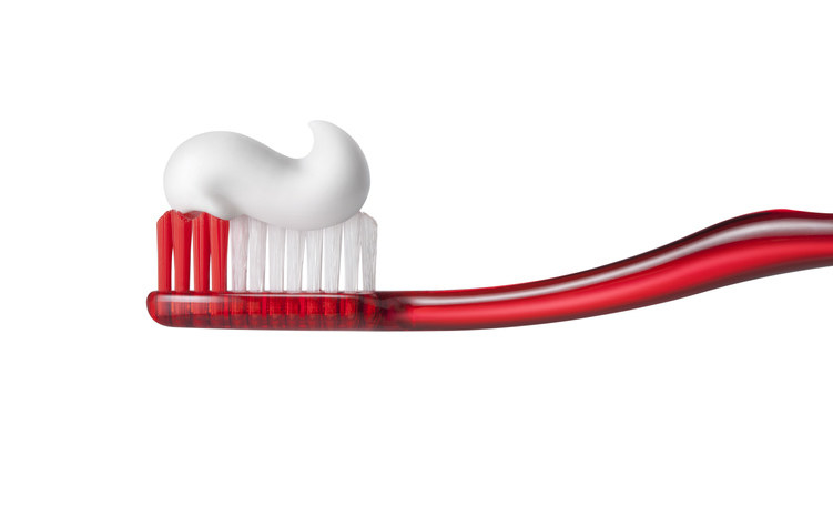 Photo of a toothbrush with a big dollop of toothpaste.