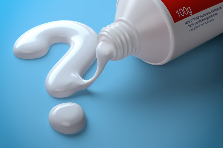 Photo of toothpaste and question mark.
