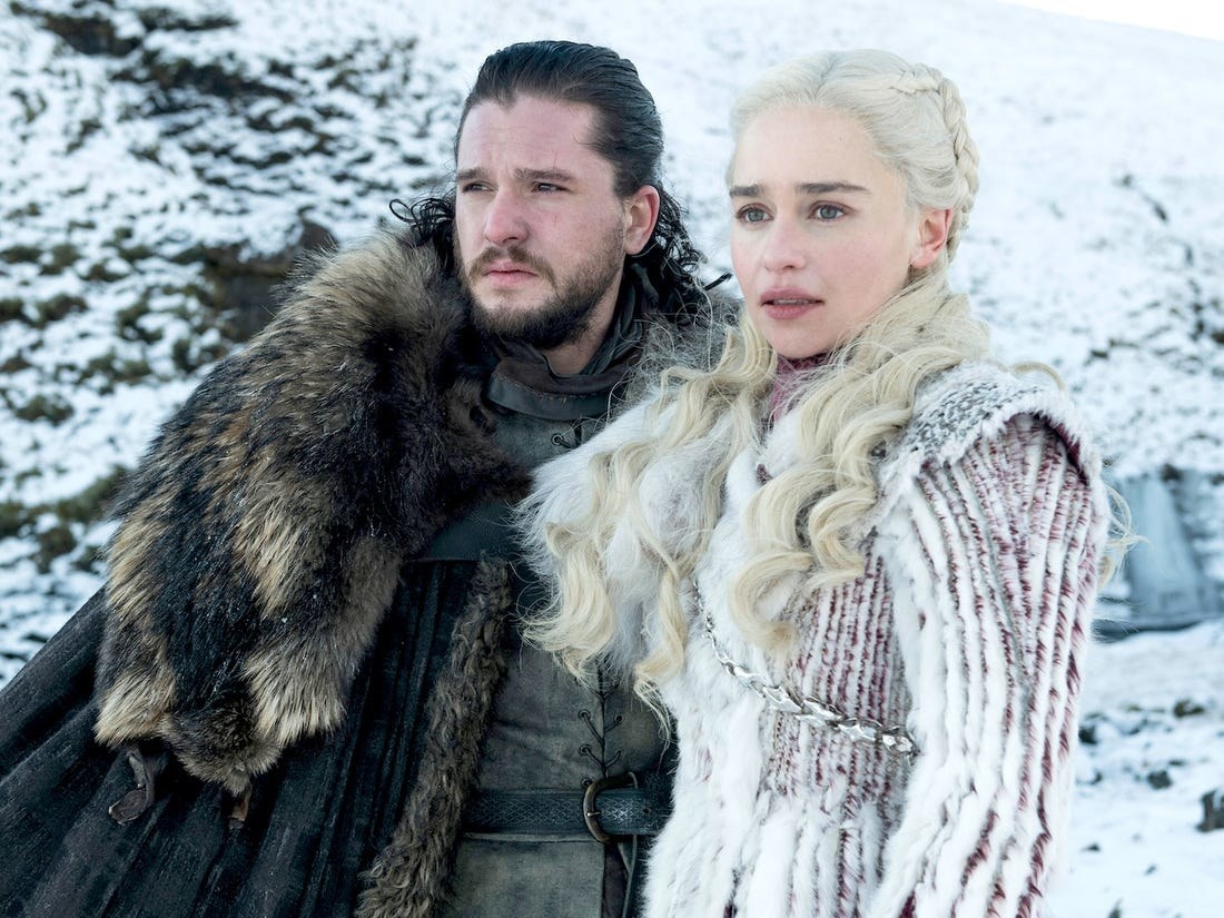 Jon and Daenerys standing together in the snow, looking into the distance