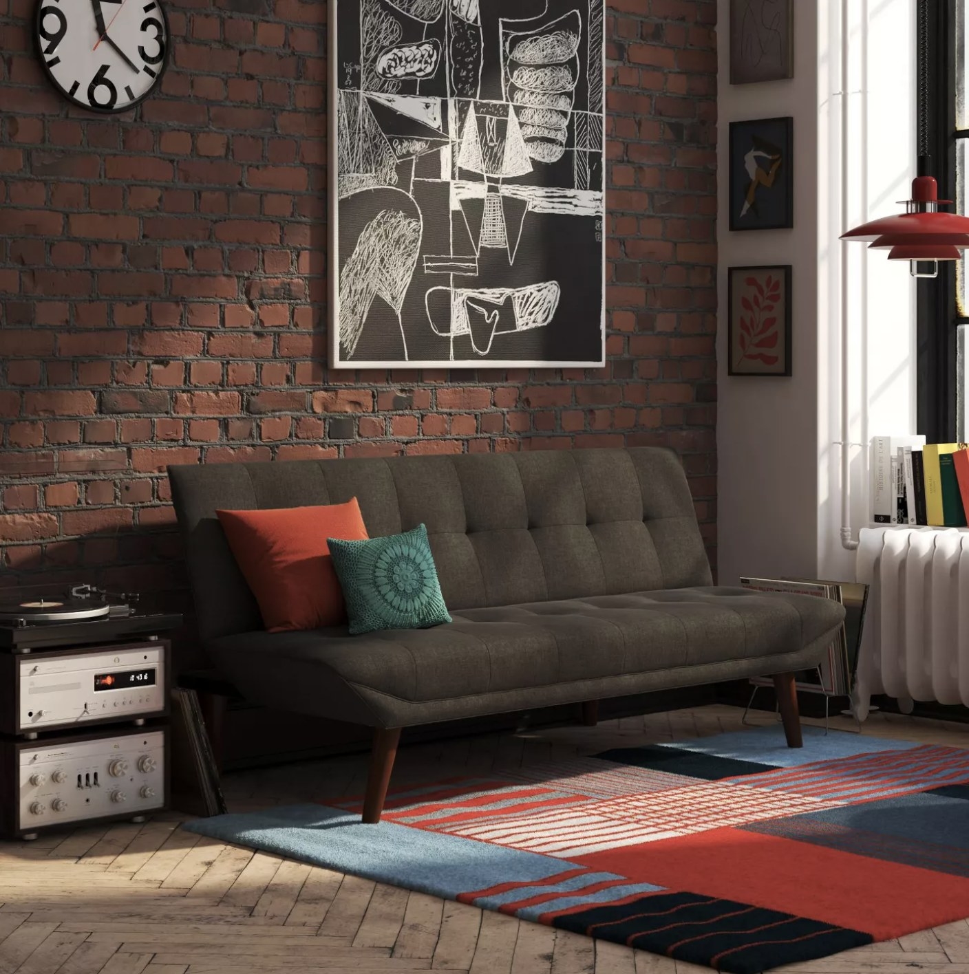 A charcoal futon couch in a living room