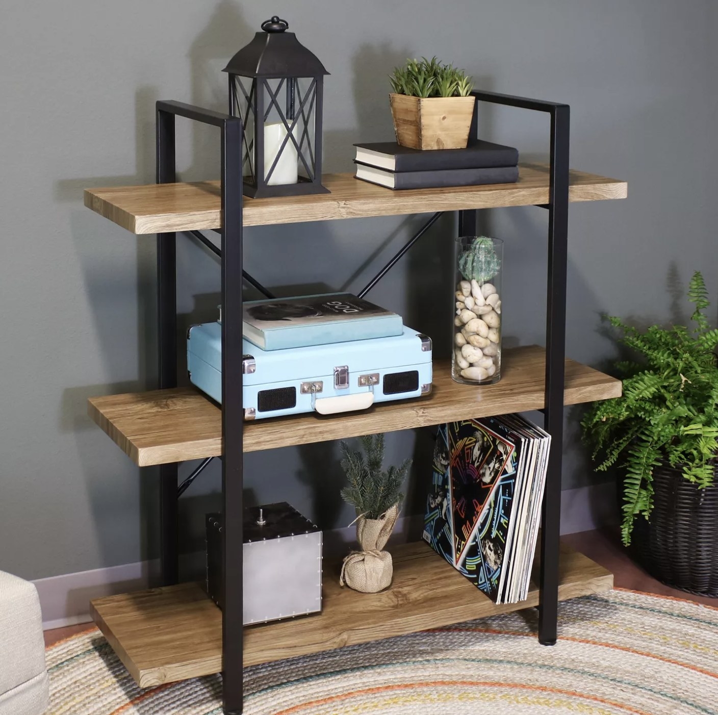 A three-tier open shelf with decor on it