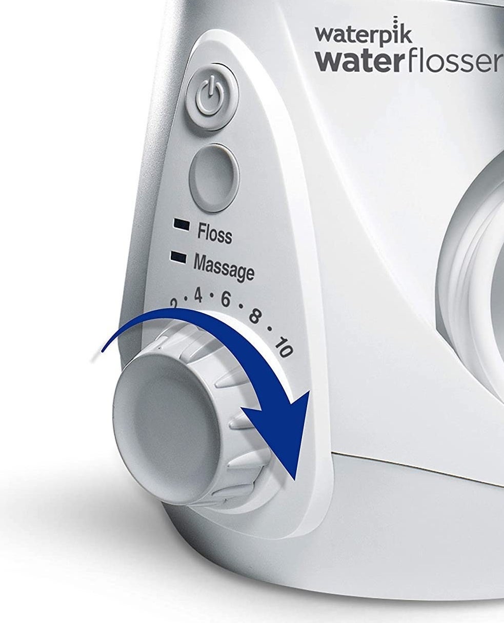 A close up of the flosser&#x27;s knob that show the pressure settings and modes