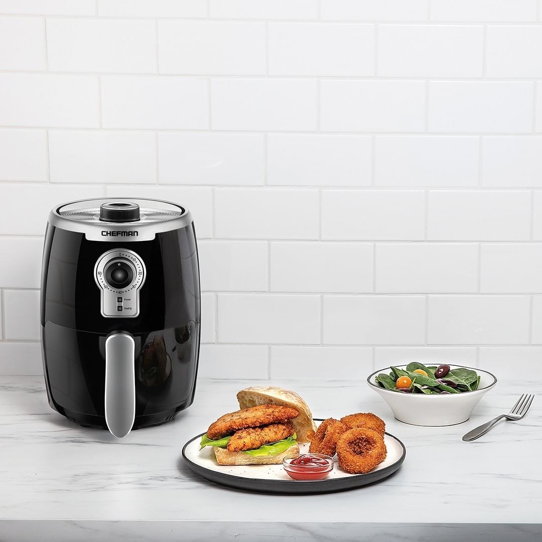 The air fryer next to onion rings and chicken fingers
